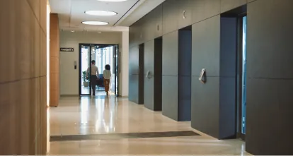 Colleagues walking down an office building hallway